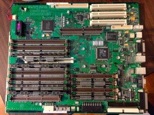 To replace the Power Macintosh 8500's on-board battery (upper left corner of photo), you have to remove the motherboard. 