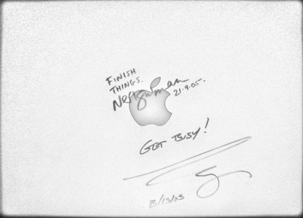 Neil Gaiman and Bruce Campbell autographs on lid of Powerbook G4.