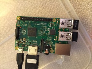 The Raspberry Pi connected from left to right: micro USB power input from 5v power supply, HDMI, wireless keyboard/trackpad receiver, and wifi adapter.
