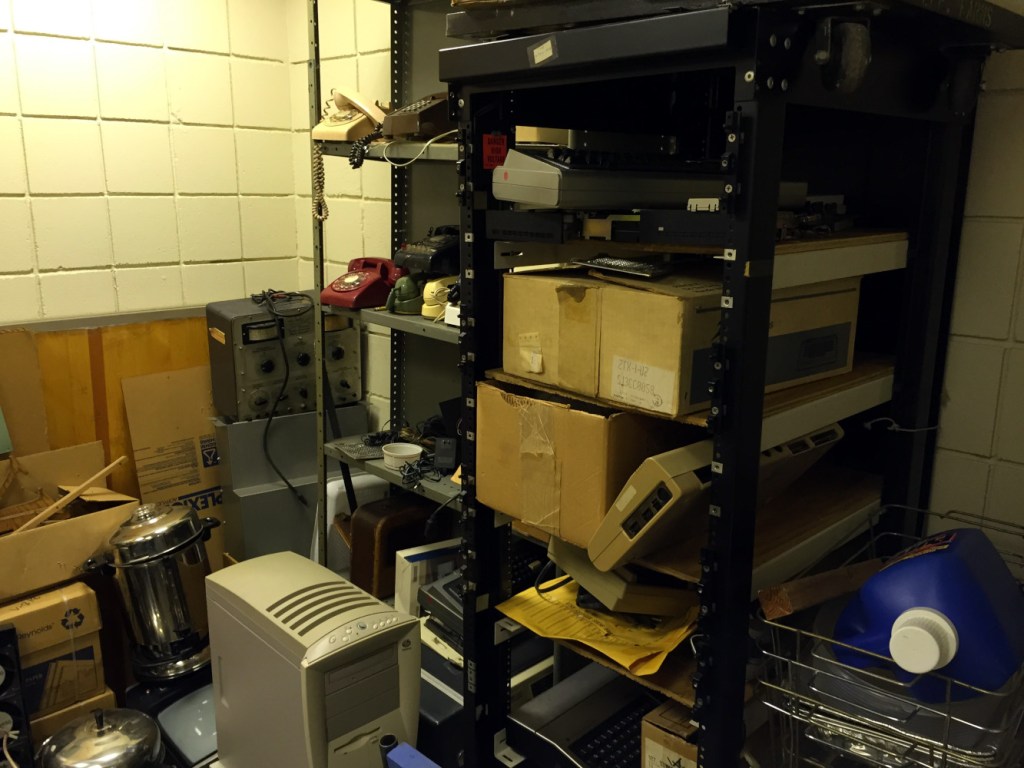 Shelves holding numerous vintage computers.