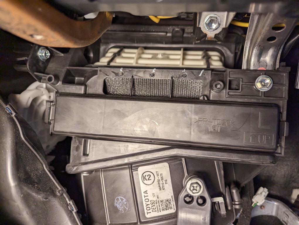 2013 Toyota Corolla cabin air filter assembly DIY replacement duct cover above filter.