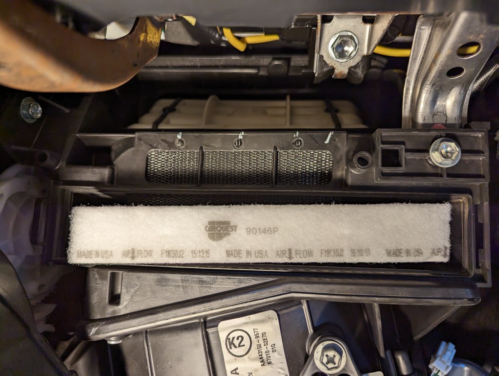 2013 Toyota Corolla cabin air filter assembly DIY replacement duct cover above filter.