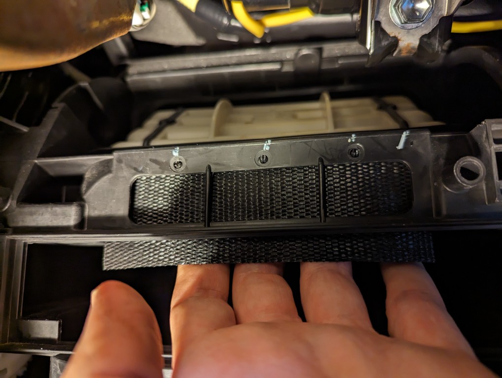 2013 Toyota Corolla cabin air filter assembly DIY replacement duct cover above filter.