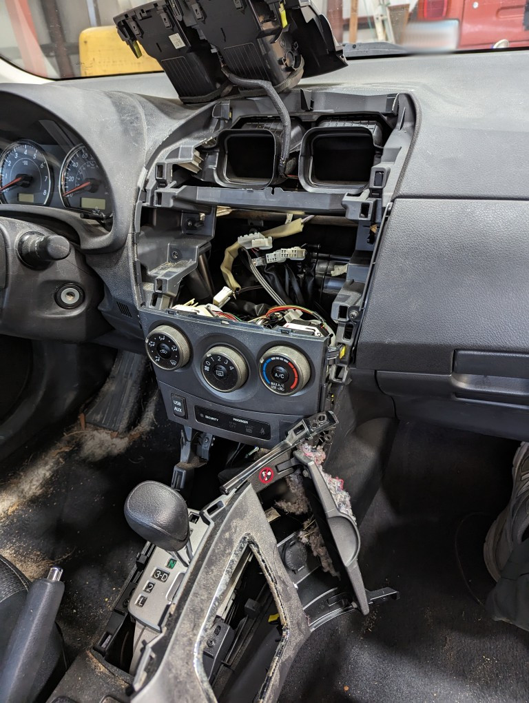 2013 Toyota Corolla center console disassembled to reach a rat's nest.