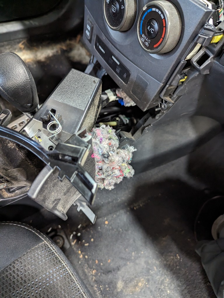 2013 Toyota Corolla center console disassembled to reach a rat's nest.
