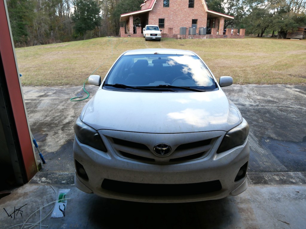 Working on the front bumper of 2013 Toyota Corolla.