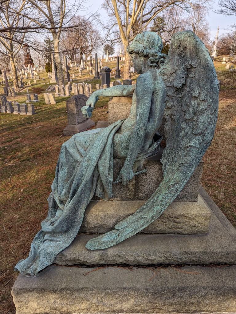 Benjamin Franklin Romain memorial with bronze angel statue in repose. In Green-Wood Cemetery, Brooklyn, New York.