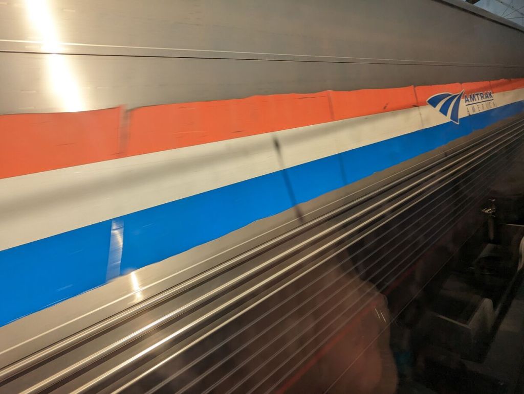 Side of passing Amtrak passenger train