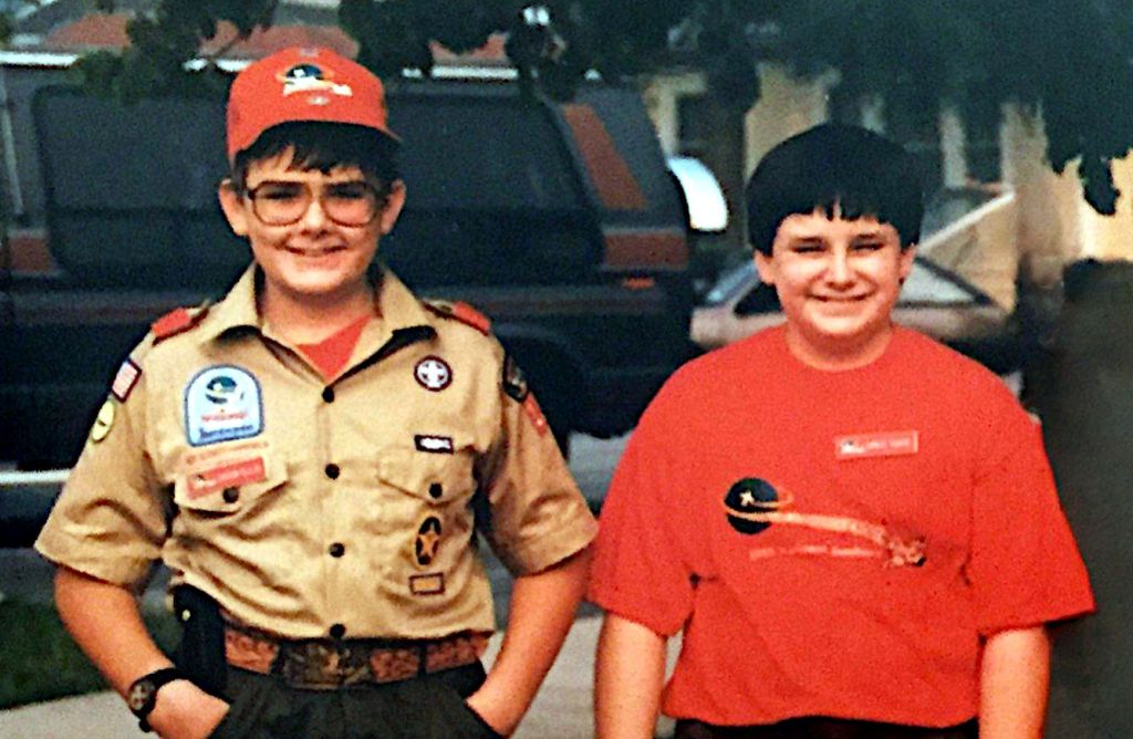 Jason Ellis on the left wearing a Boy Scout uniform and Greg Doke on the right wearing a scouting t-shirt. Other people in the image have been removed using Stable Diffusion and inpaint+lama.