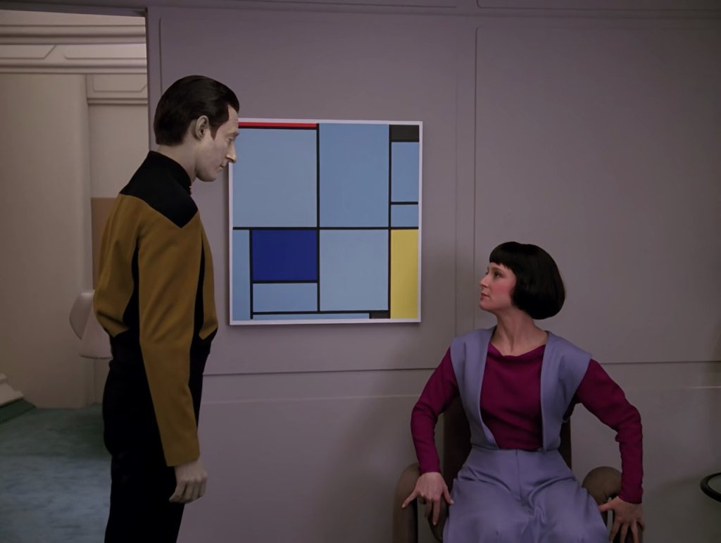 Piet Mondrian's "Tableau I" hands on a wall between Lt. Cmd. Data standing and his daughter Lal sitting.