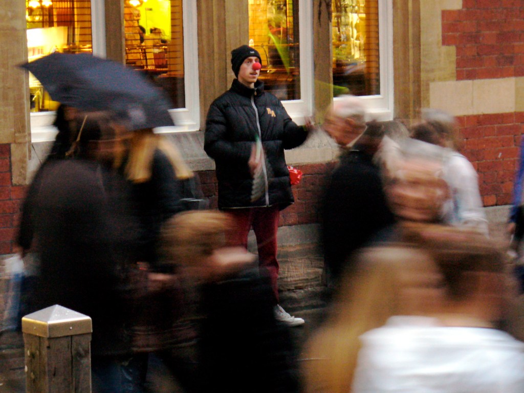 Juggler in action in a dynamic crowd of people