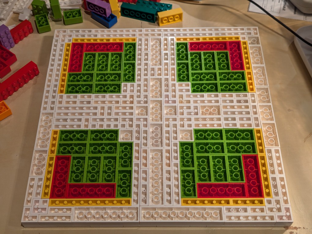LEGO white plates in a 32x32 layout upside down with bricks filling the full layout