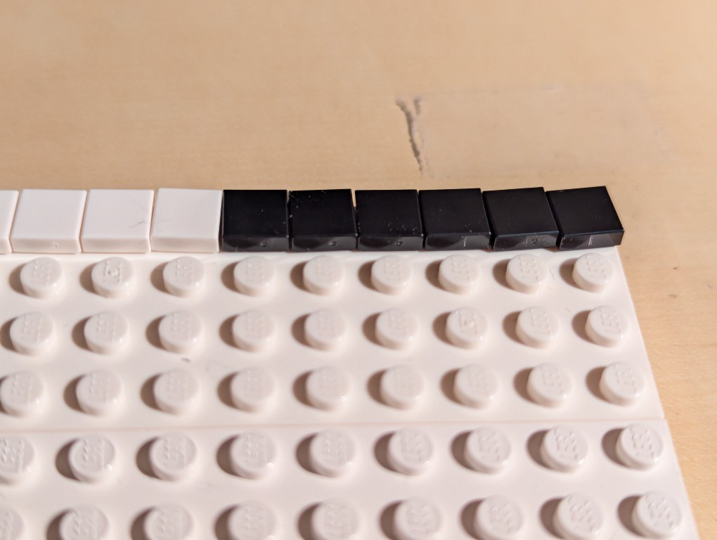 LEGO 1x1 flat tiles skewed at different angles after connecting to LEGO plate