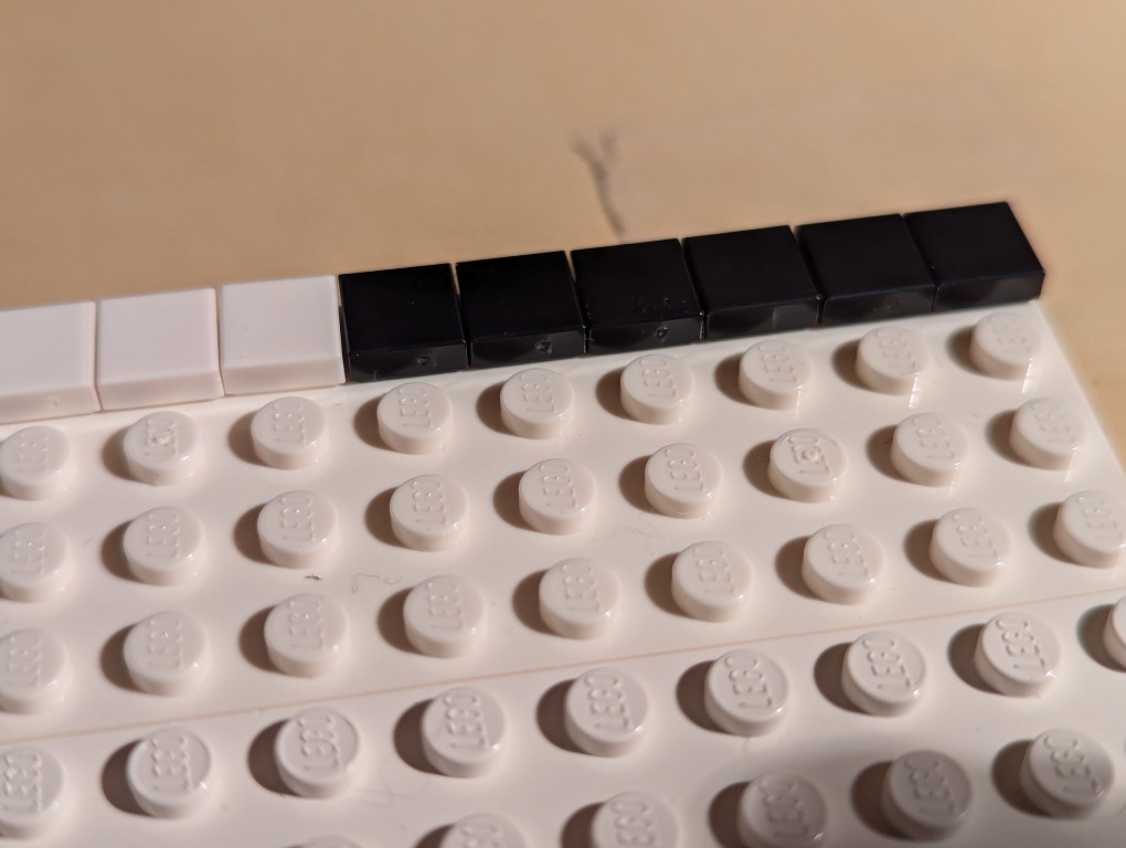 Straight aligned row of 1x1 flat tile LEGO