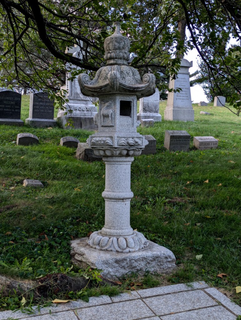 stone japanese lantern in graveyard
