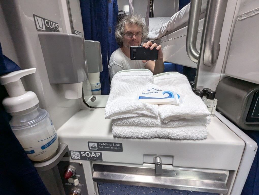 amtrak roomette sink mirror with towels and soap and drinking cups