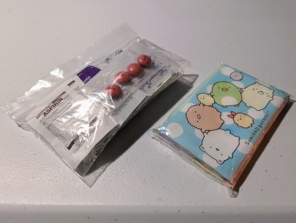 a ziploc full of first aid supplies and a small packet of tissues