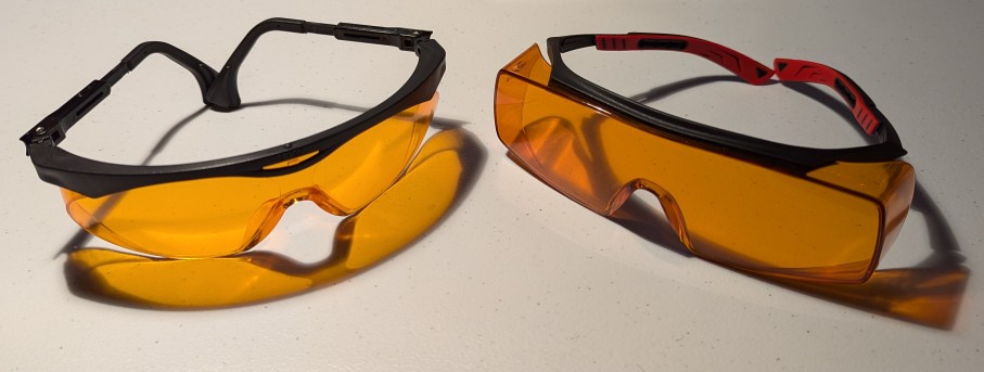 2 pairs of orange colored glasses