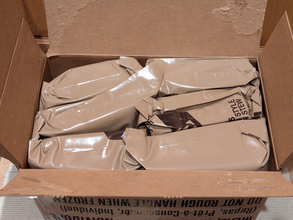 open cardboard case of mres, 6 mres shown.