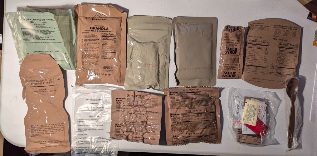 mre contents spread out, an assortment of pouches and bags with different food items inside