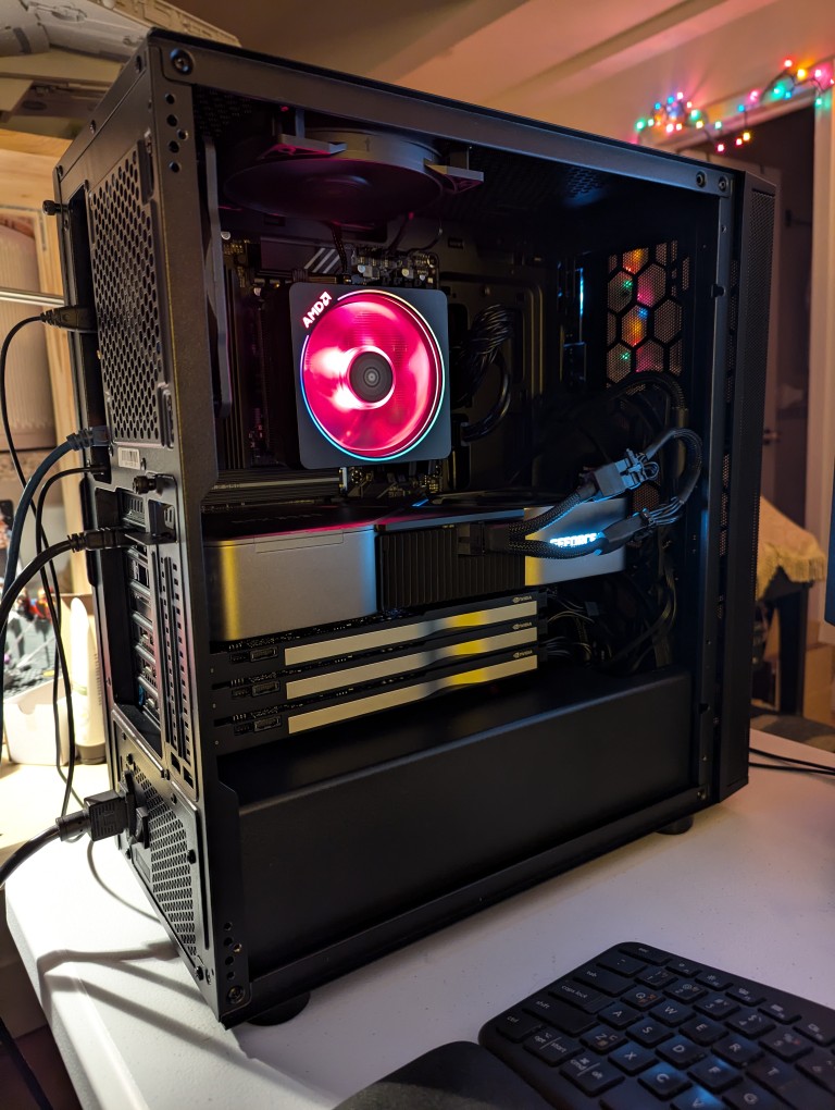 black computer tower with side panel removed showing the internal components