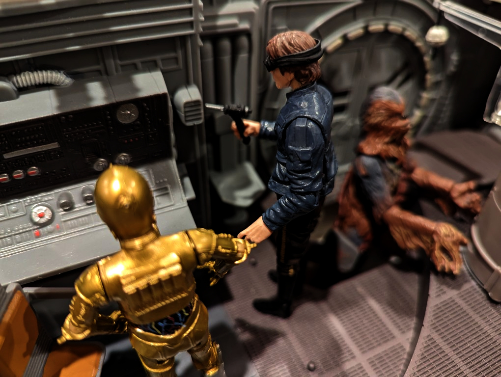 droid, man, and a wookie inside a spacecraft making repairs