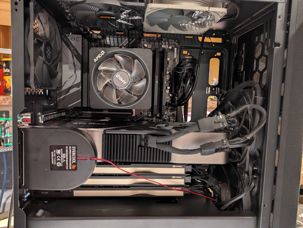 side view of computer case interior with slot fan above the four video cards