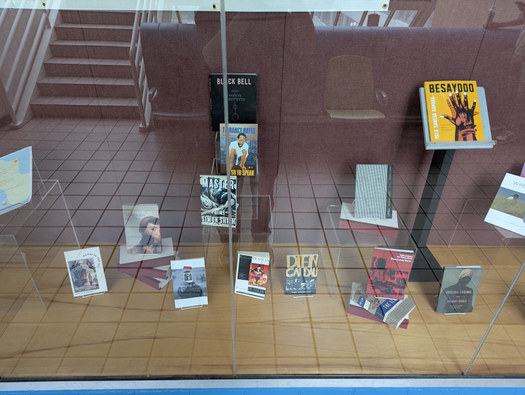 display of books and banner for national poetry month behind a large glass facade