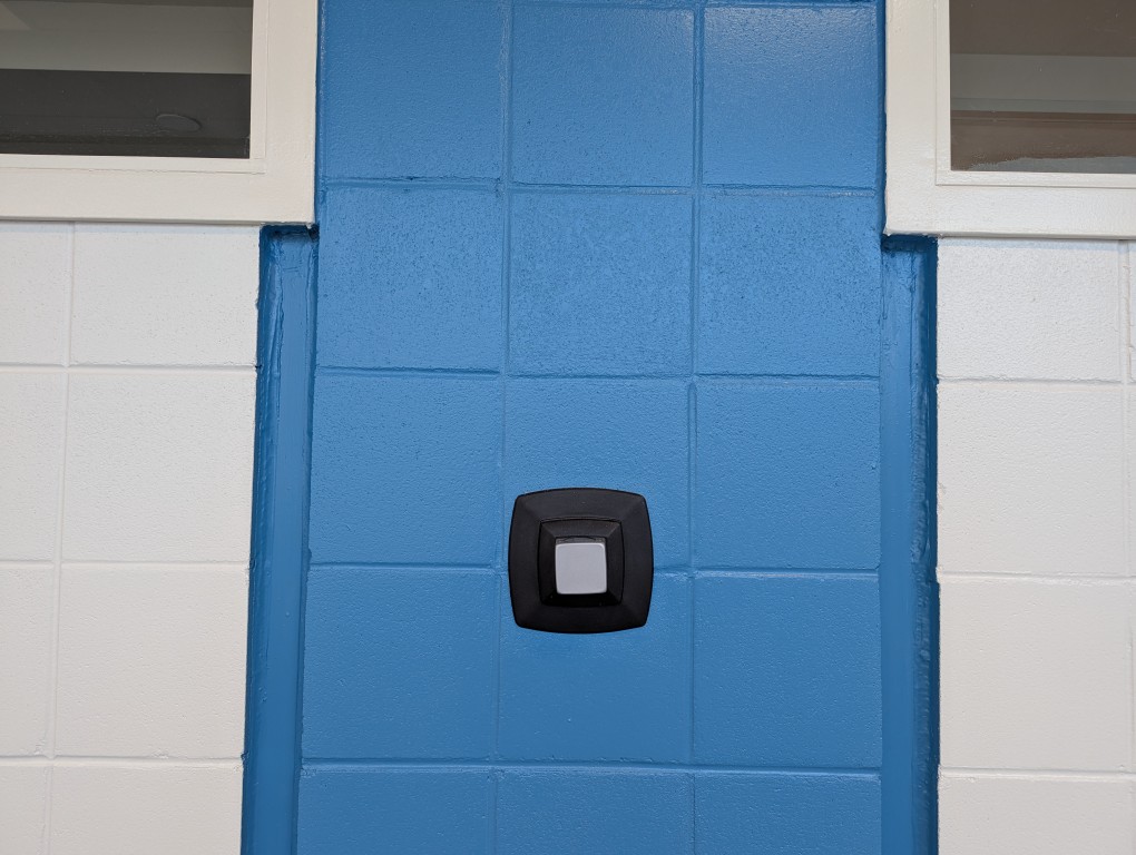 windows and thermostat make a face on a block wall