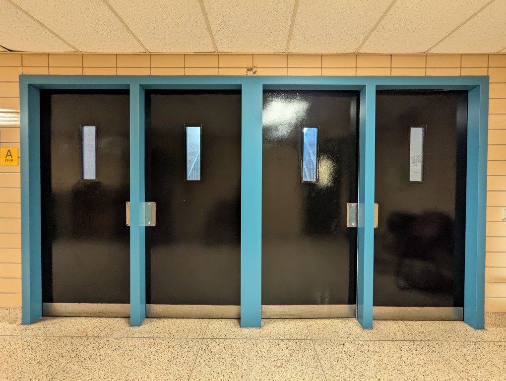 four black doors with blue trim