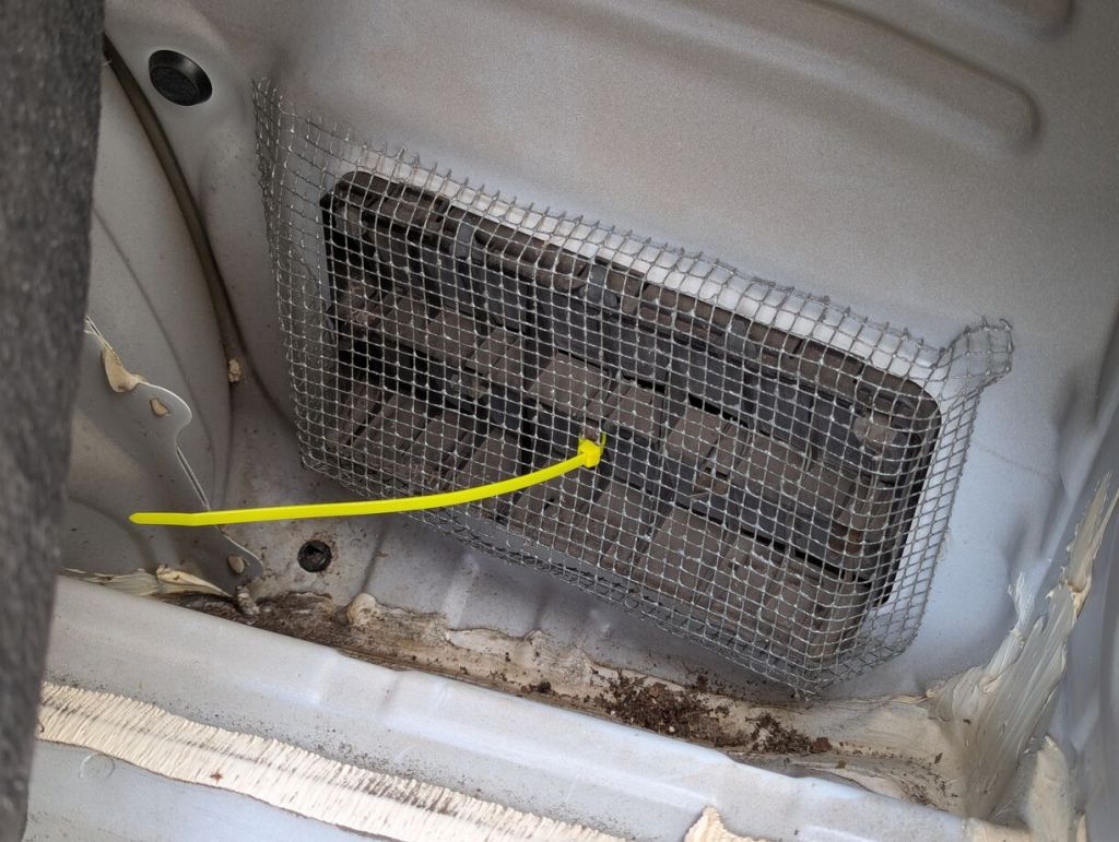 wire mesh shaped over pressure vent and secured with zip tie