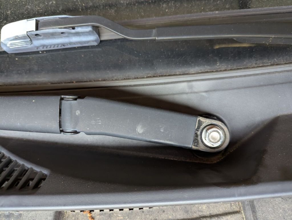 closeup of windshield wiper arm bolt assembly