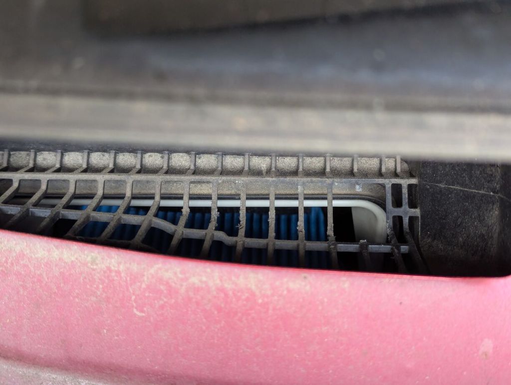 cabin air intake plastic grill with section missing likely chewed through by mice