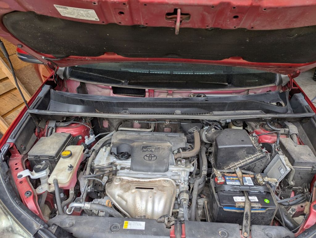 under hood of 2017 rav4 with windshield cowl removed to reveal cabin air intake on left side