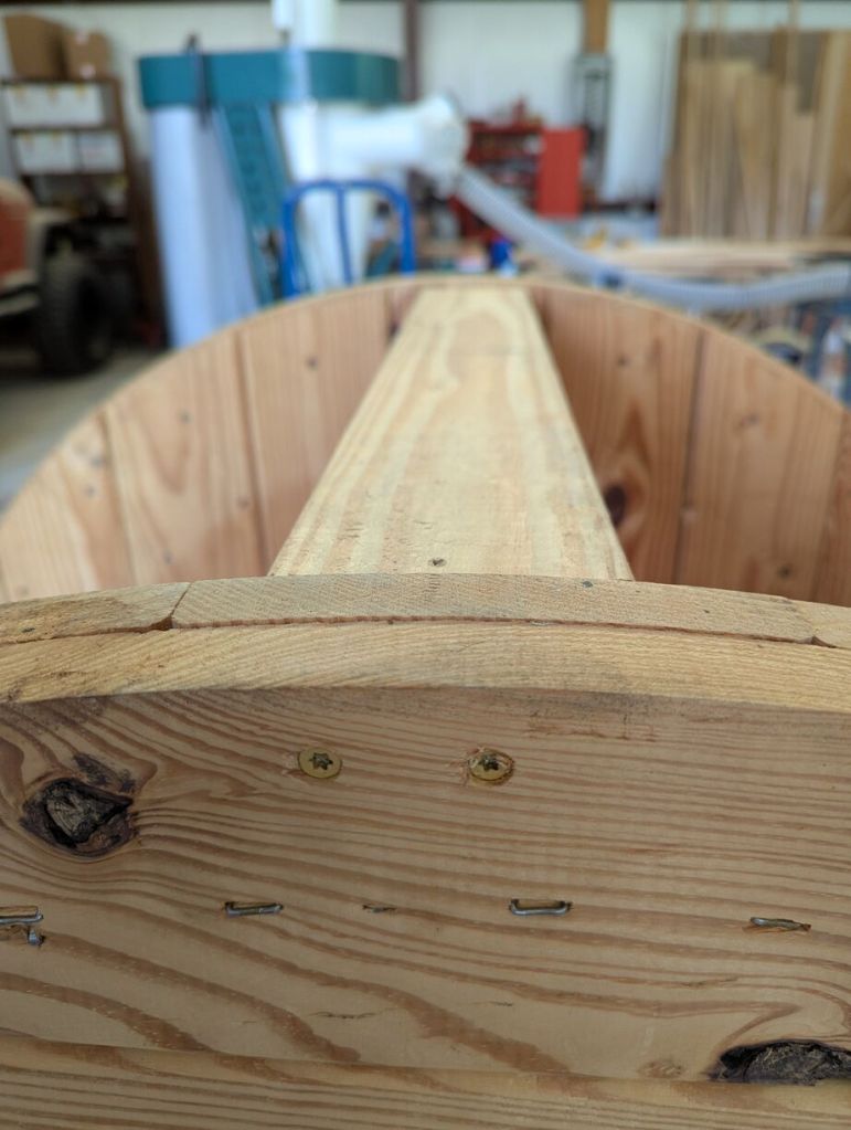 closeup of screws driven through top surface of workbench into 2x4