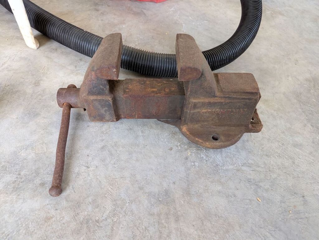 large metal vice sitting on the concrete floor