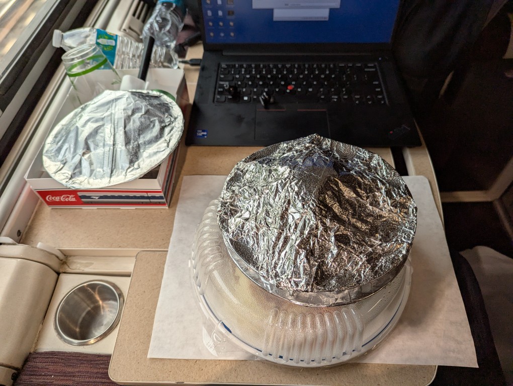 in-car dinner service, dinner packages are wrapped in foil and plastic
