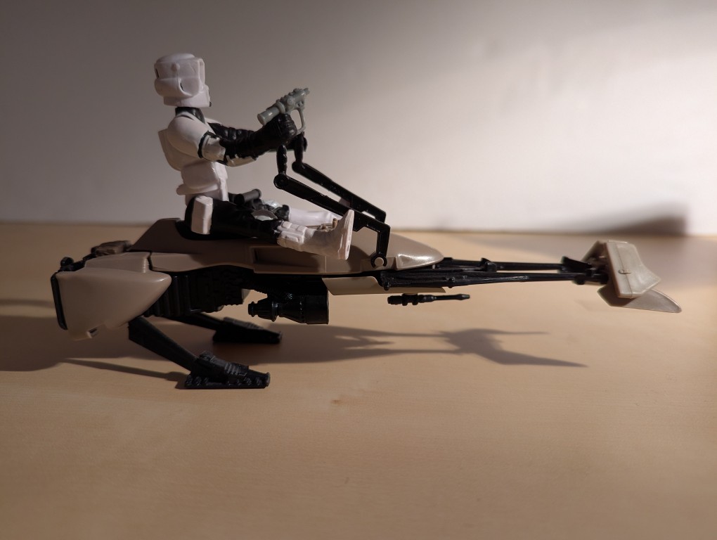 kenner speeder bike toy with a biker scout sitting on top holding the handles and a blaster pistol, right side view