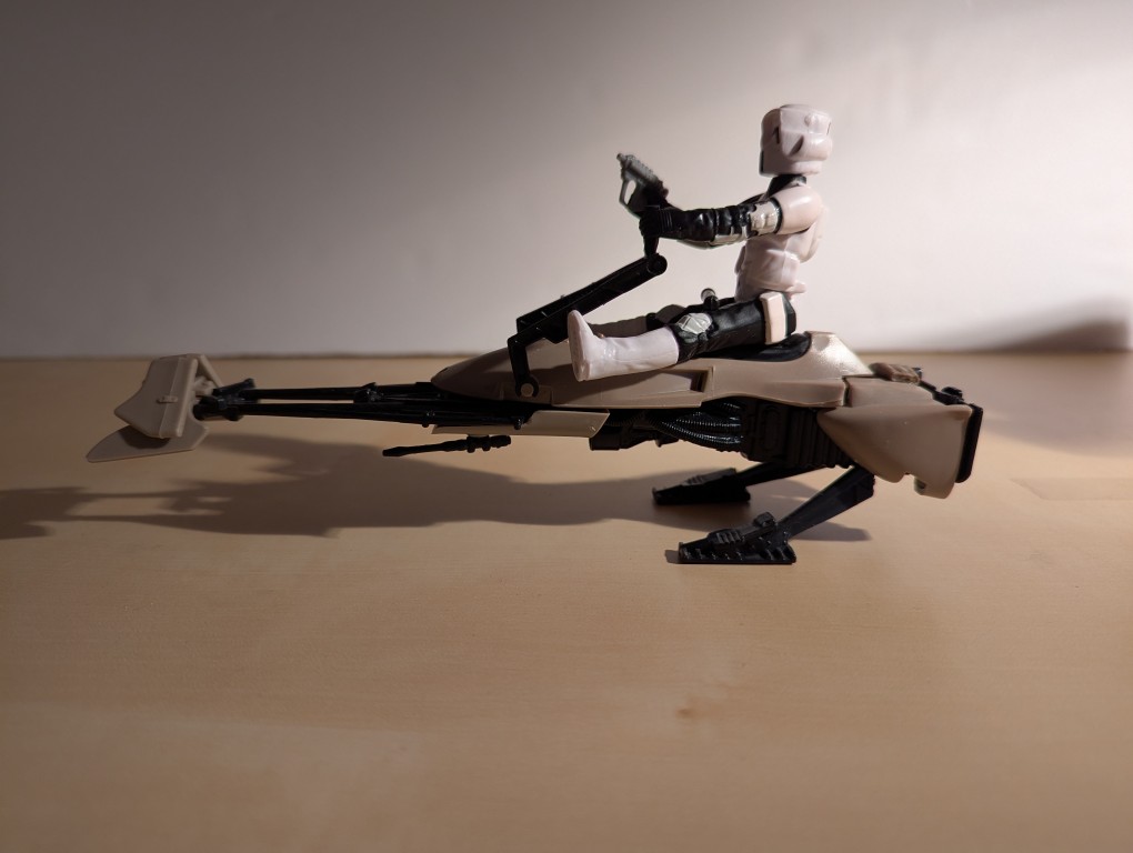 kenner speeder bike toy with a biker scout sitting on top holding the handles and a blaster pistol, right side view