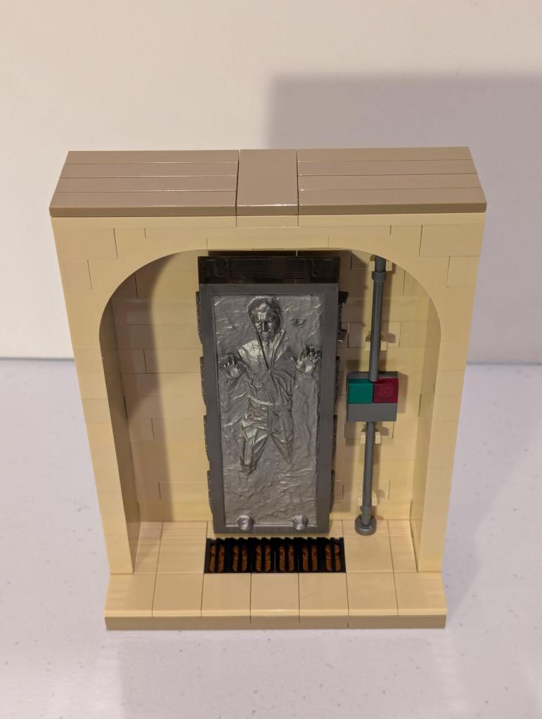 Han Solo in Carbonite displayed in an alcove of Jabba's Palace built out of tan LEGO bricks.