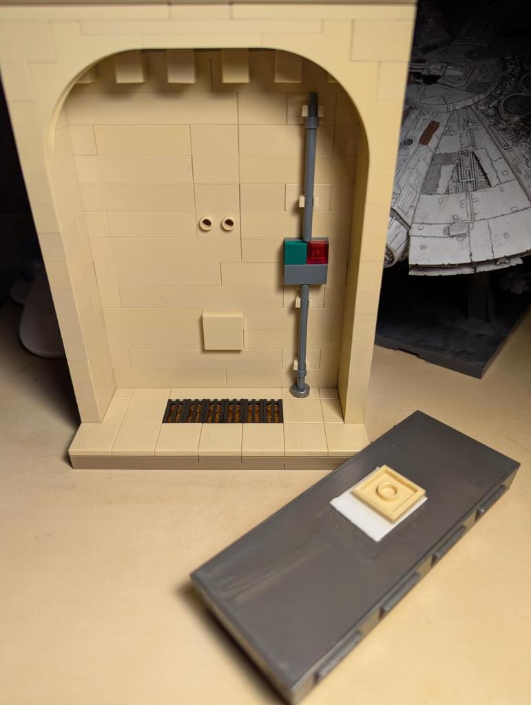 Han Solo in Carbonite displayed in an alcove of Jabba's Palace built out of tan LEGO bricks.