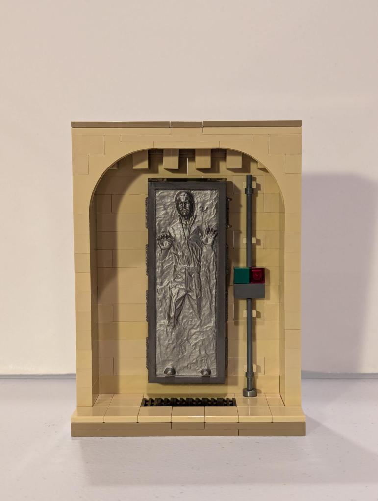 Han Solo in Carbonite displayed in an alcove of Jabba's Palace built out of tan LEGO bricks.