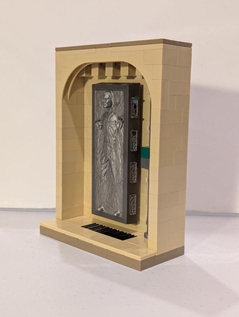 Han Solo in Carbonite displayed in an alcove of Jabba's Palace built out of tan LEGO bricks.