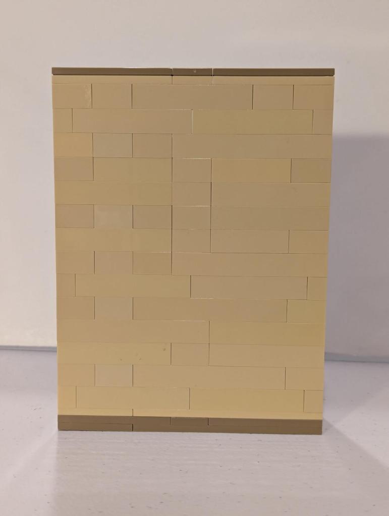 Han Solo in Carbonite displayed in an alcove of Jabba's Palace built out of tan LEGO bricks.