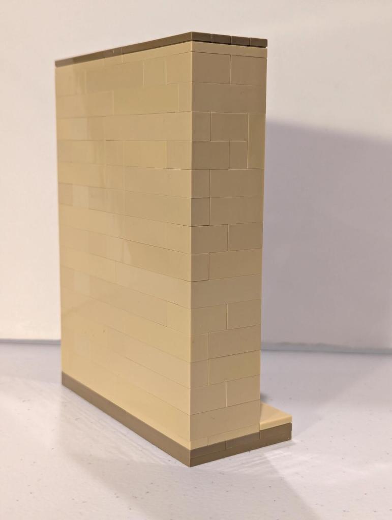 Han Solo in Carbonite displayed in an alcove of Jabba's Palace built out of tan LEGO bricks.