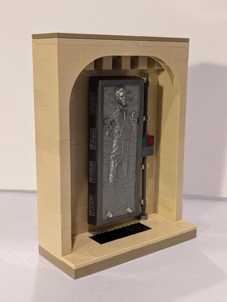 Han Solo in Carbonite displayed in an alcove of Jabba's Palace built out of tan LEGO bricks.